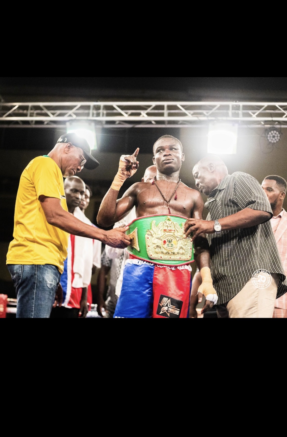 Ringside ceremony — moments after the final bell.