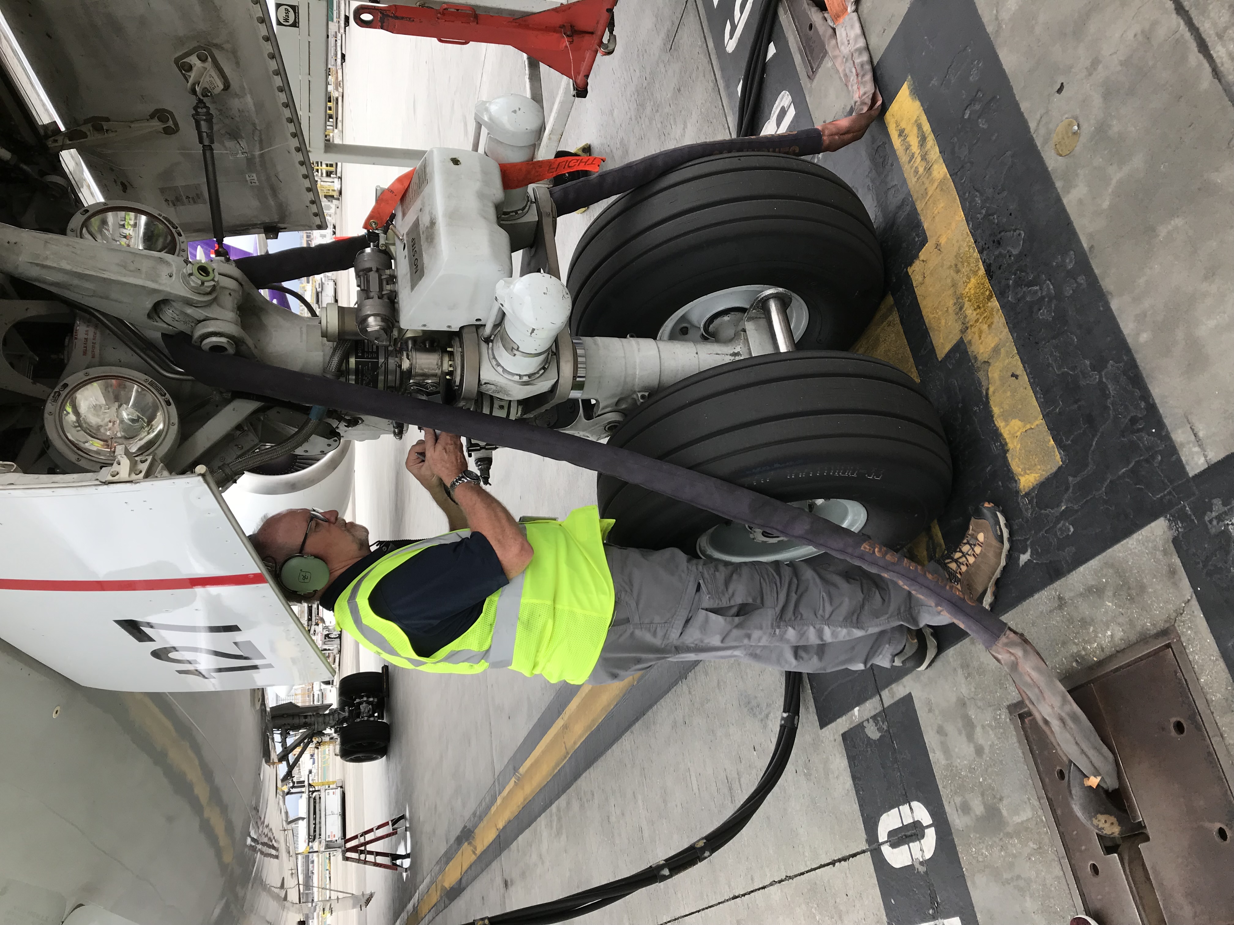 Technician inspecting aircraft landing gear