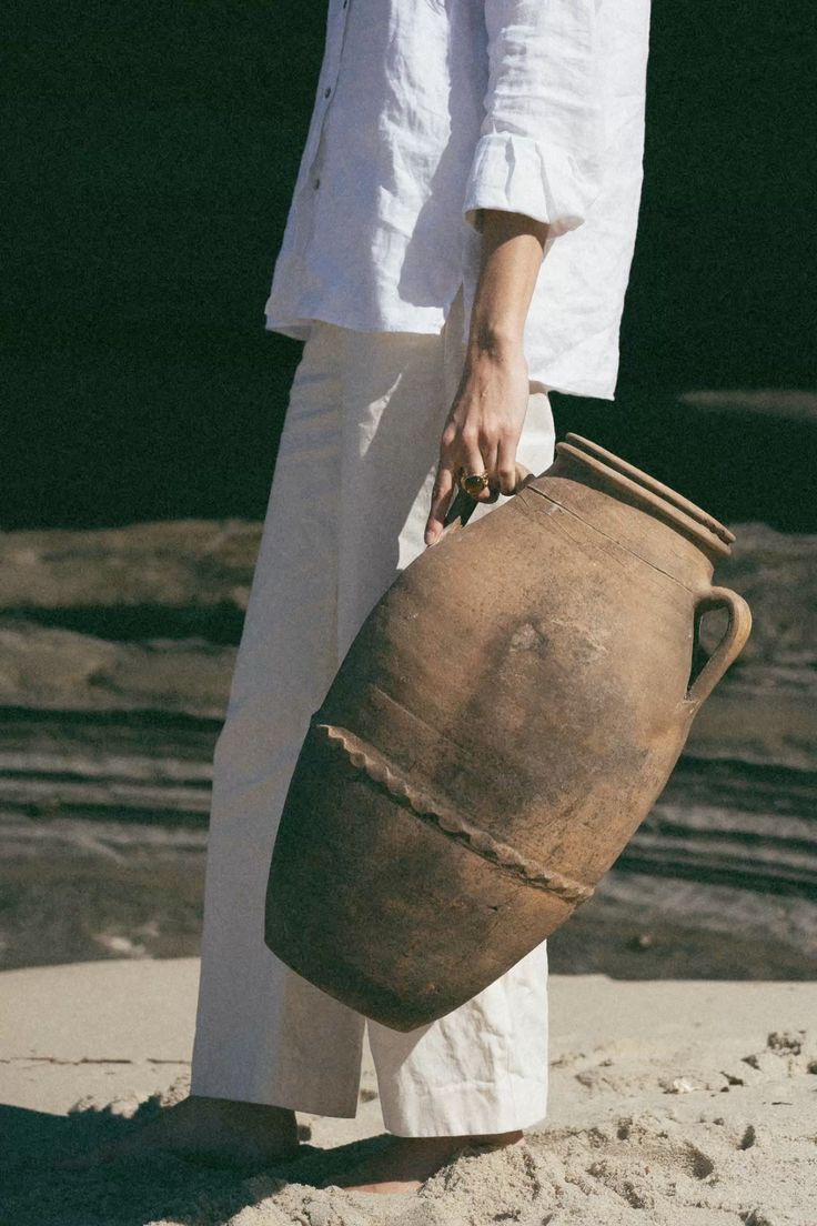 A woman carrying a clay vessel