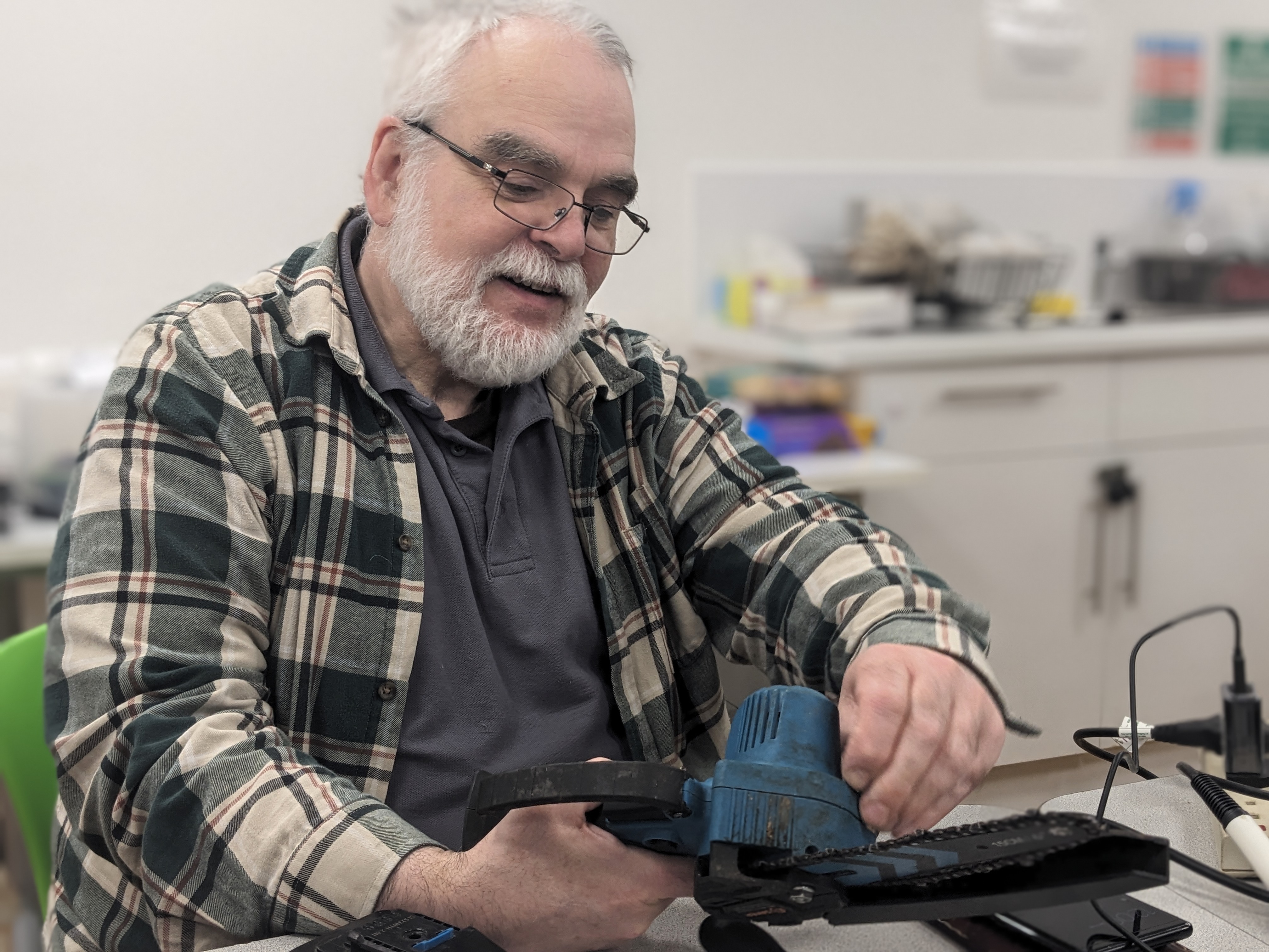 Tim with a mini chainsaw — Tesco Community Room