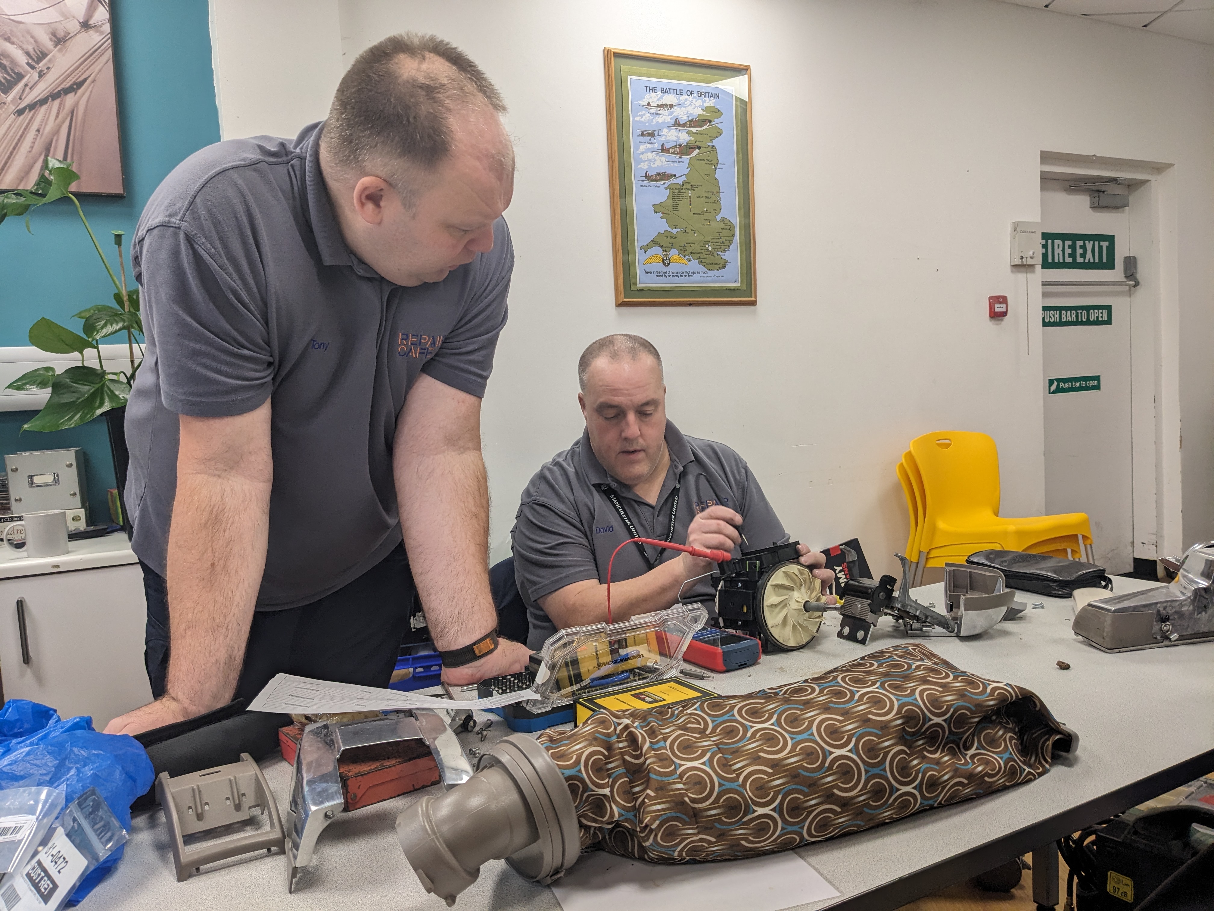 Tony and David fixing a vacuum — Tesco Community Room
