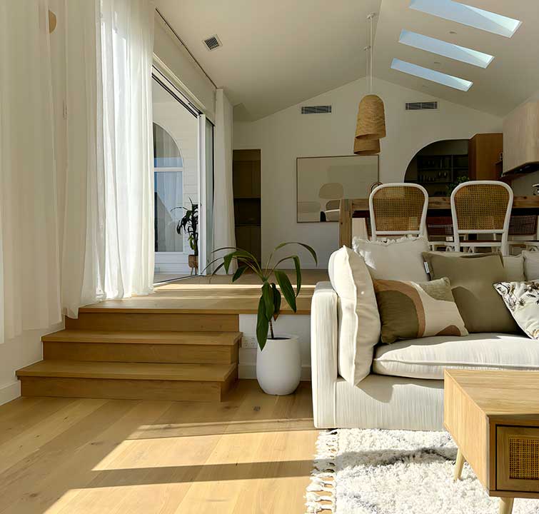 Brazier Building & Design — coastal interior with timber floors and skylight