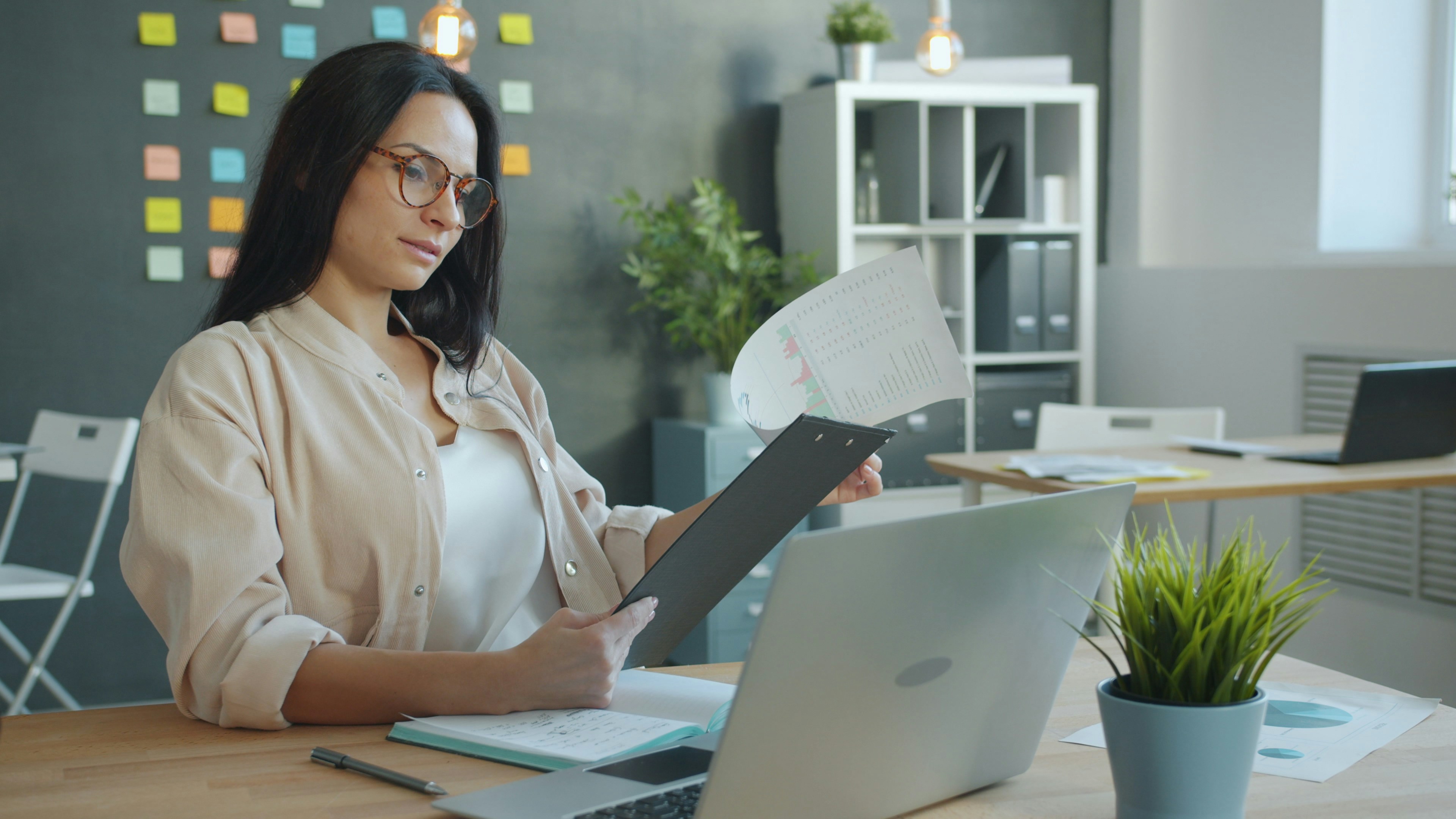 A small team reviewing business documents together at a laptop — illustrating the manual document triage process that small businesses face every week.