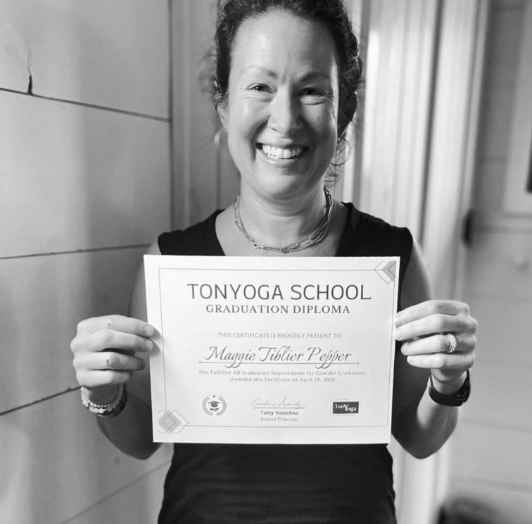 Tonyoga School graduate holding her diploma