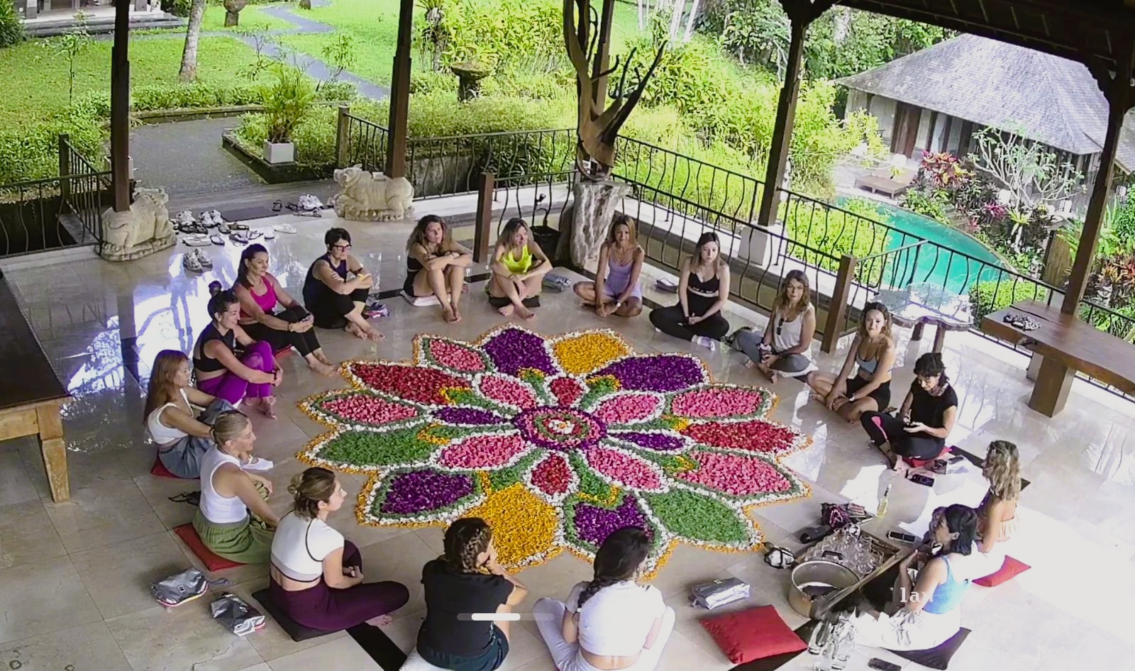 Aerial view of yoga session with flower mandala