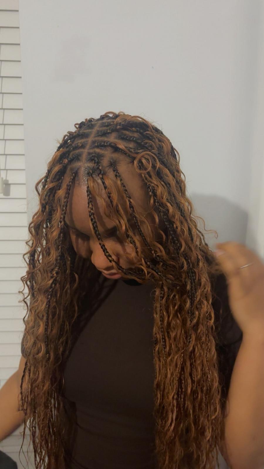 Knotless braid installation in progress, parting work visible