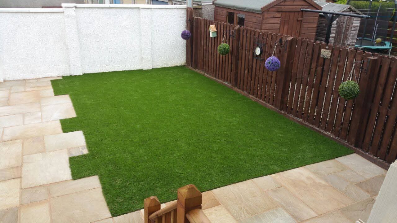 Garden with hanging baskets and stone slab paving — Last Cut Landscaping